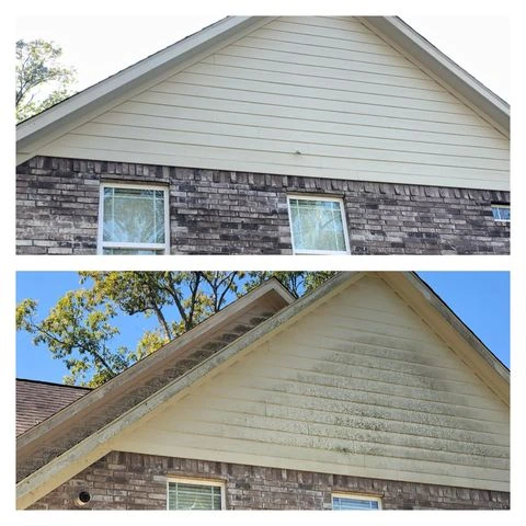 Close-up of siding being cleaned with soft washing techniques on a Hamilton home to restore its original look.